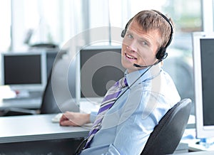 Happy young business man in headphone looking at camera