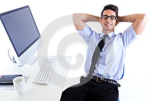 Happy young business man relaxing in modern office