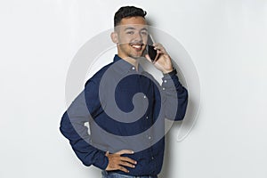 Happy young business man using mobile phone isolated on white background