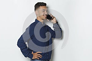 Happy young business man using mobile phone isolated on white background