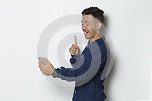 Happy young business man using mobile phone isolated on white background