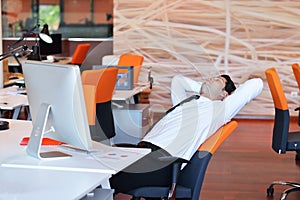 Happy young business man work in modern office on computer