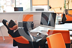 Happy young business man work in modern office on computer