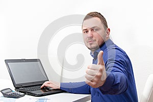 Happy young business man work in modern office on computer