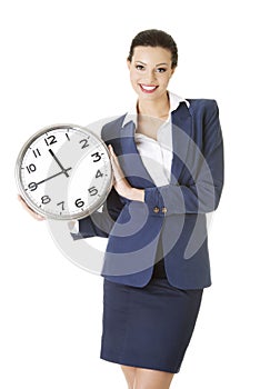 Happy young business woman holding office clock