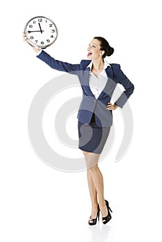 Happy young business woman holding office clock