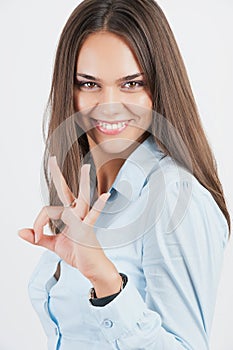 Happy young business woman with okay gesture