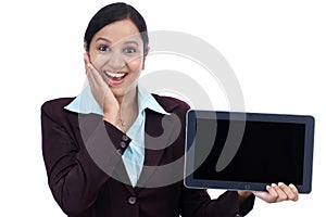 Happy young business woman showing tablet