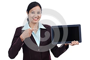Happy young business woman showing tablet