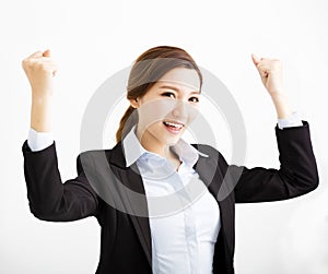 Happy young business woman with success gesture