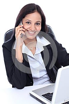 Happy young business woman talking on mobile phone