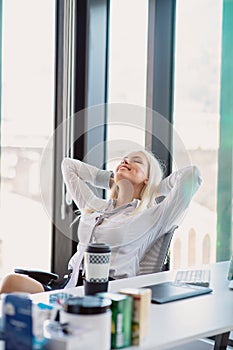 Happy young business women relaxing and geting insiration while working on desktop computer at modern bright starup