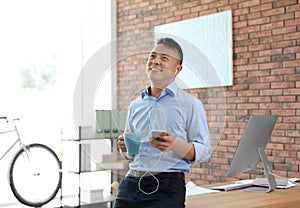 Happy young businessman with mobile phone