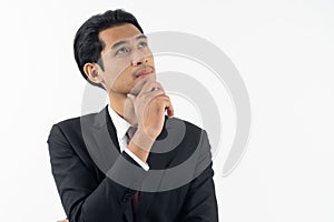 happy young businessman smiling and thinking in formal suit isolated on white background