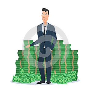 Happy young businessman standing near a huge pile of green