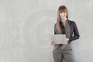 Happy young businesswoman with laptop computer