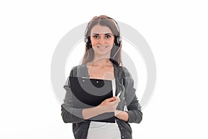 Happy young call center office girl with headphones and microphone looking at the camera and smiling with board in her