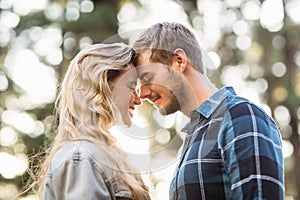 Happy young camper couple touching foreheads