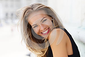 Happy young carefree woman smiling outdoor portrait