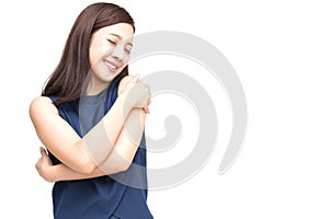 Happy young casual asian woman hugging herself isolated on white background.