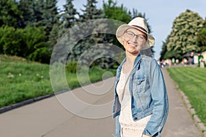 Happy young caucasian bald woman in hat and casual clothes enjoying life after surviving breast cancer. Portrait of