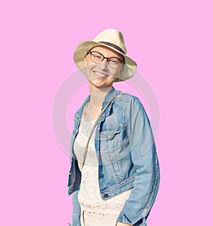 Happy young caucasian bald woman in hat and casual clothes enjoying life after surviving breast cancer. Portrait of beautiful