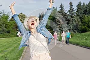 Happy young caucasian bald woman in hat and casual clothes enjoying life after surviving breast cancer. Portrait of beautiful