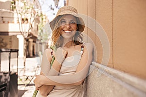 Happy young caucasian blonde woman spends leisure time outdoors on warm day.