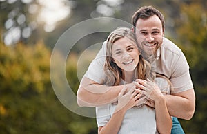 Happy young caucasian couple bonding at the park or garden outside in nature. Affectionate husband and wife embracing