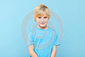 Happy young caucasian preschooler boy in casual outfit smiling, looking at camera.