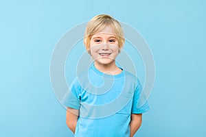 Happy young caucasian preschooler boy in casual outfit smiling, looking at camera, isolated.