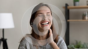 Happy young caucasian red-haired woman laughing at funny joke.