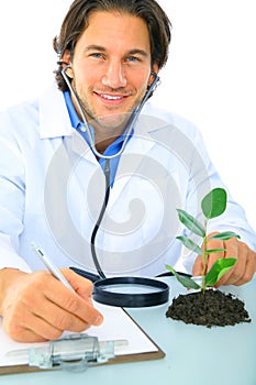 Happy Young Caucasian Scientist Analyze Plant