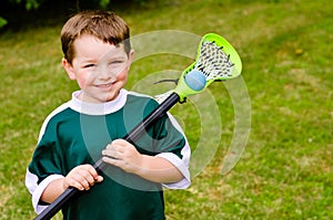 Happy young child lacrosse player