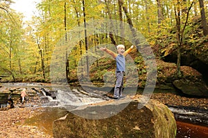 Happy Young Child Smiling with Excitement on Nature Hike near Ri