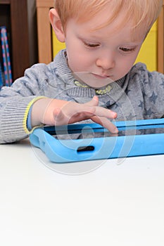 Child using a tablet touch screen device