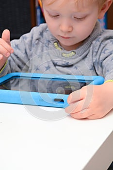 Child using a tablet touch screen device