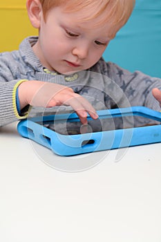 Child using a tablet touch screen device