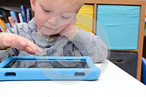 Child using a tablet touch screen device