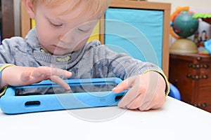 Child using a tablet touch screen device