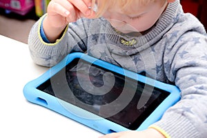 Child using a tablet touch screen device