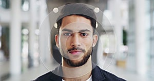 Happy, young and confident business man face laughing while standing in a modern office. Closeup portrait of a handsome