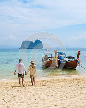 happy young couple Asian woman and European men on the beach of Koh Ngai island in Thailand