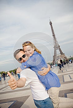 Happy young couple on the background of the Eiffel Tower in Paris. Honeymoon in Europe