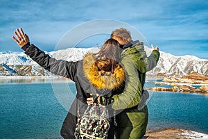 Happy young couple on the background of snowy mountains