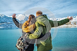 Happy young couple on the background of snowy mountains