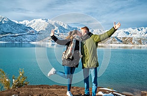 Happy young couple on the background of snowy mountains