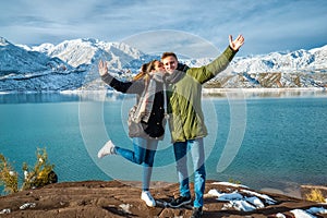 Happy young couple on the background of snowy mountains