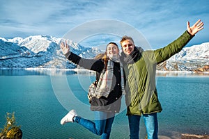 Happy young couple on the background of snowy mountains