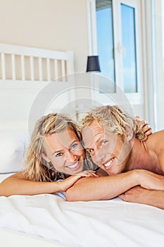 Happy young couple in bed